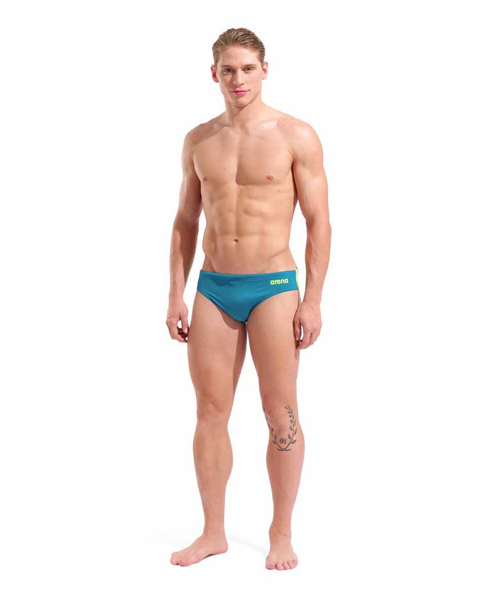 Arena men's team swim solid briefs in blue Cosmo and Arctic Lime, featuring a snug fit and quick-drying fabric.
