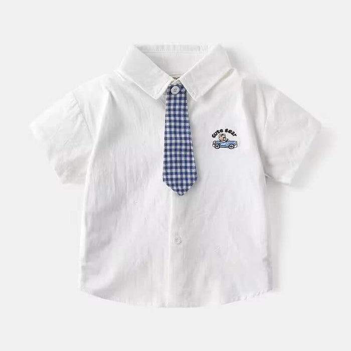 Close-up of baby boy’s checked cotton shirt pattern with matching tie – soft cotton detail